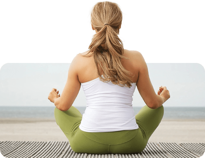 A woman sitting in the lotus position on her knees.