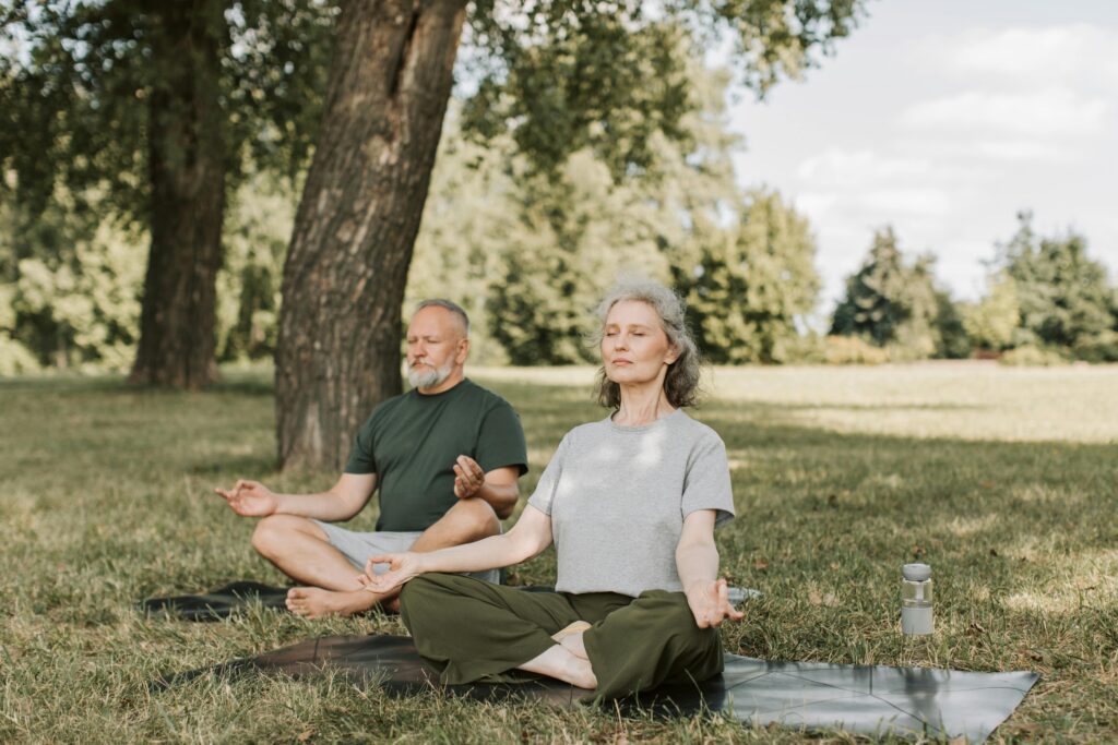 A man and woman sitting in the grass