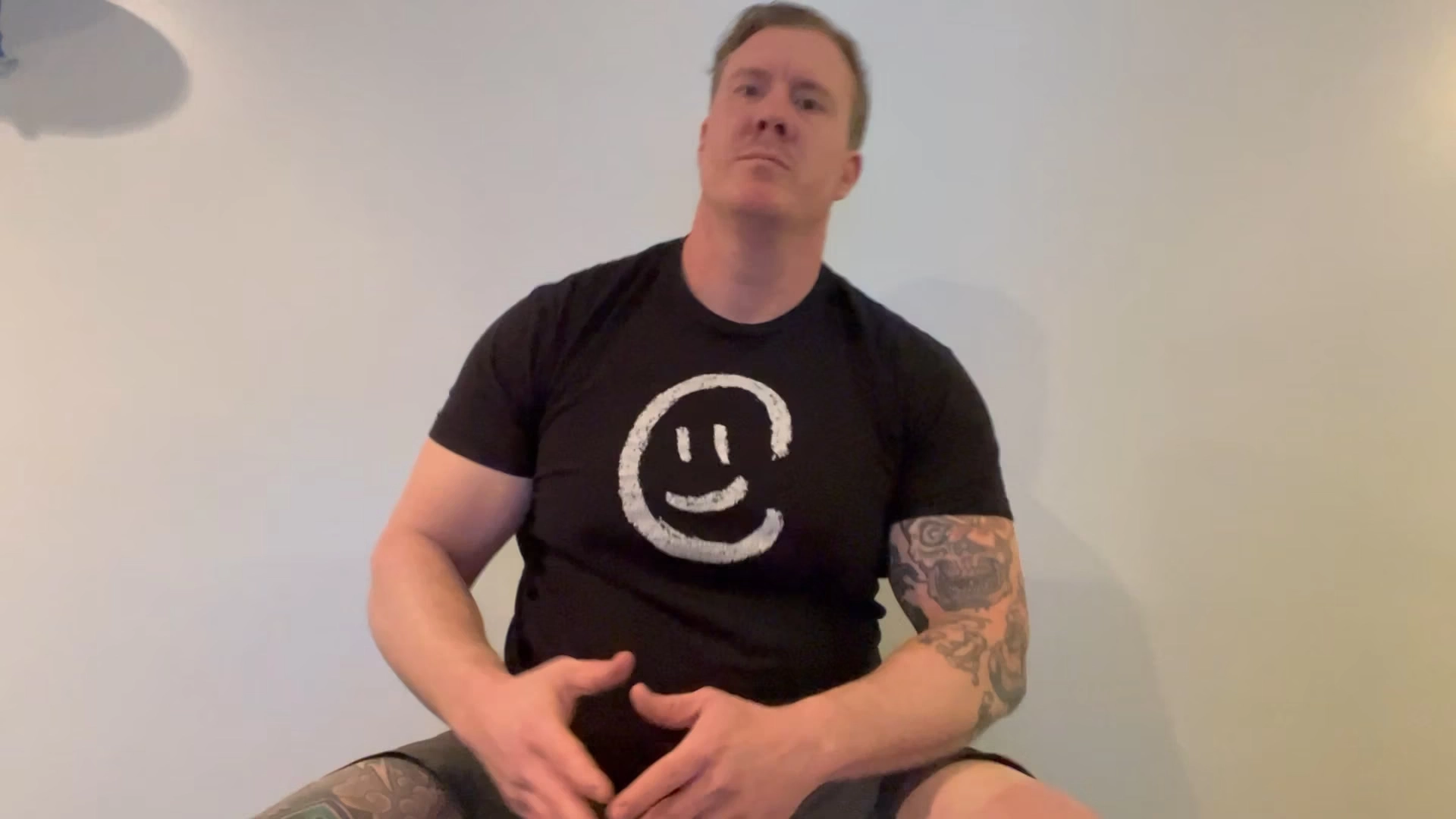 a man in a black t shirt with a smile