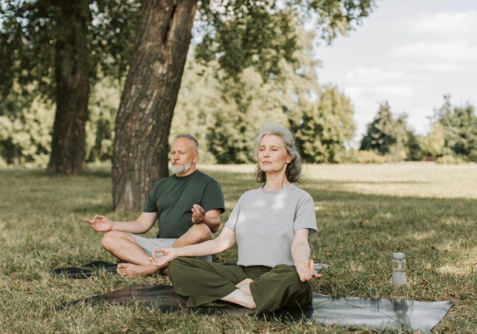 A man and woman sitting in the grass